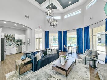 A living room with a blue couch and a coffee table